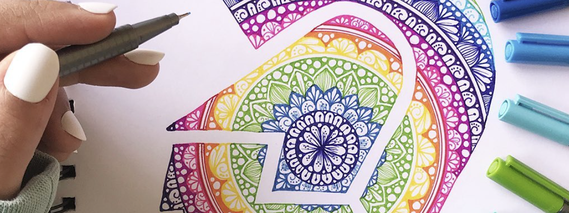 Scatto emozionale di una mano che colora un disegno vivido con matite Staedtler, evidenziando la qualità del tratto.